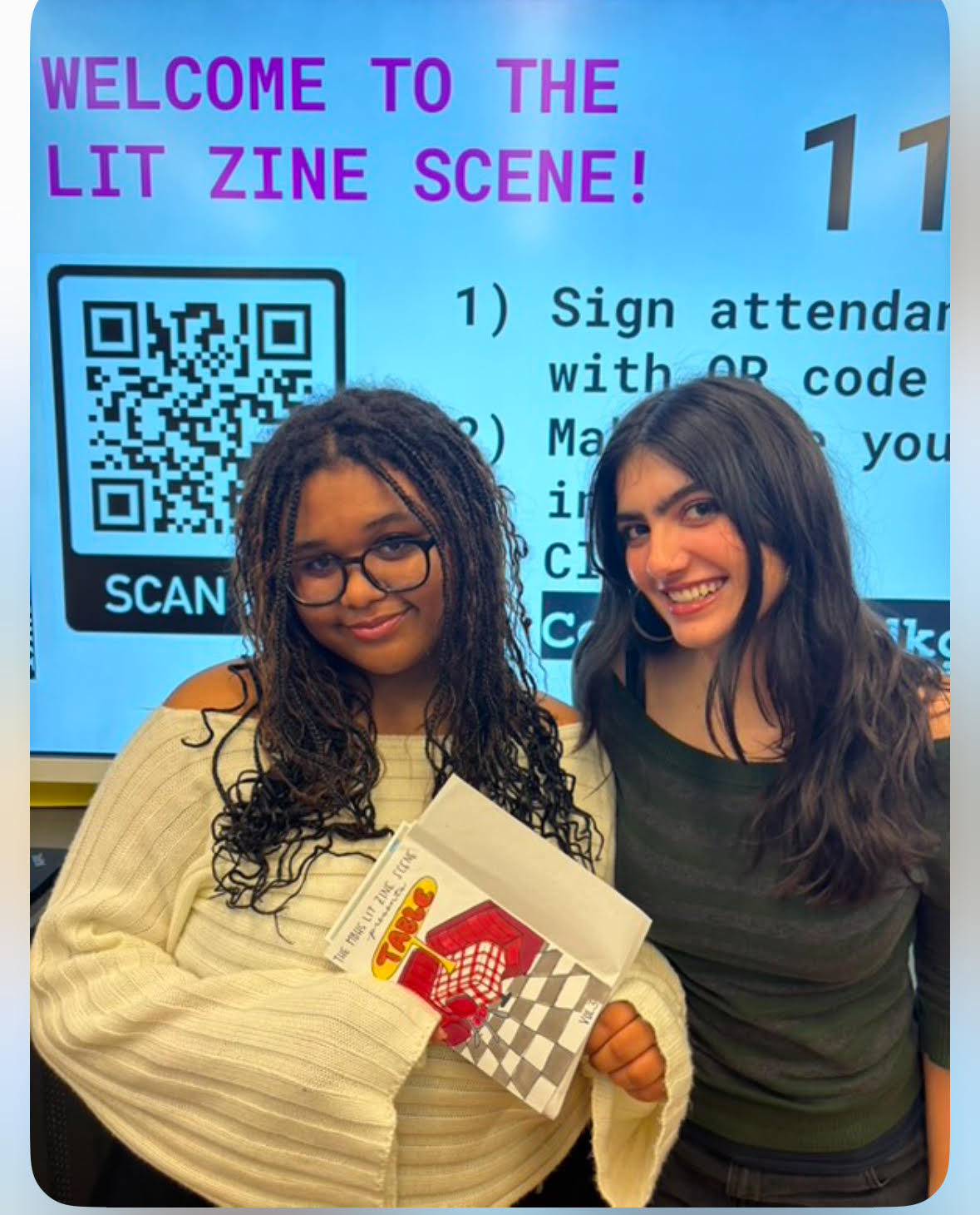 Student leaders Madison Blum (left) and Anna Calvarino (right) show off of the club's "Table" zine anthology.